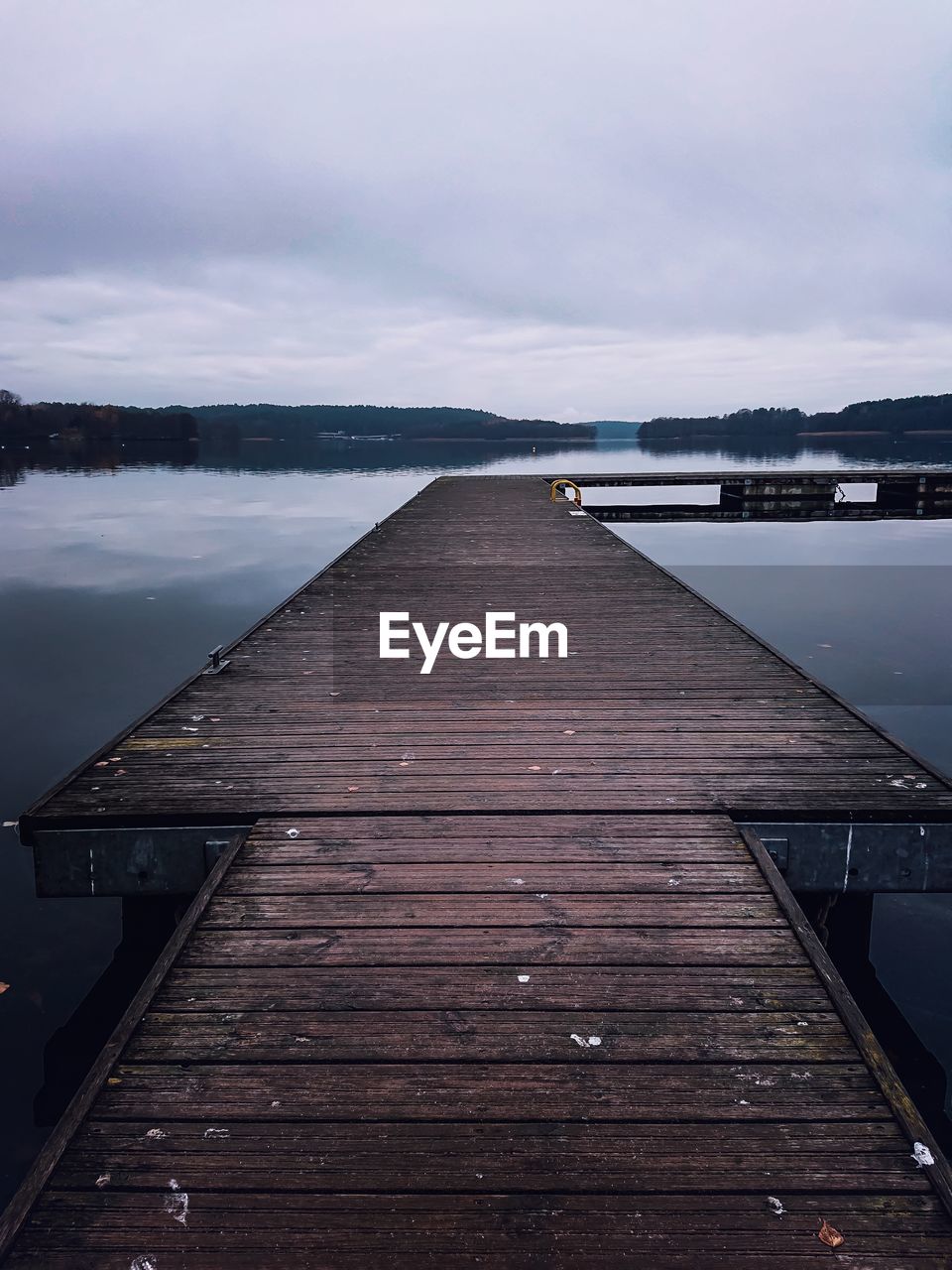 Pier over lake against sky