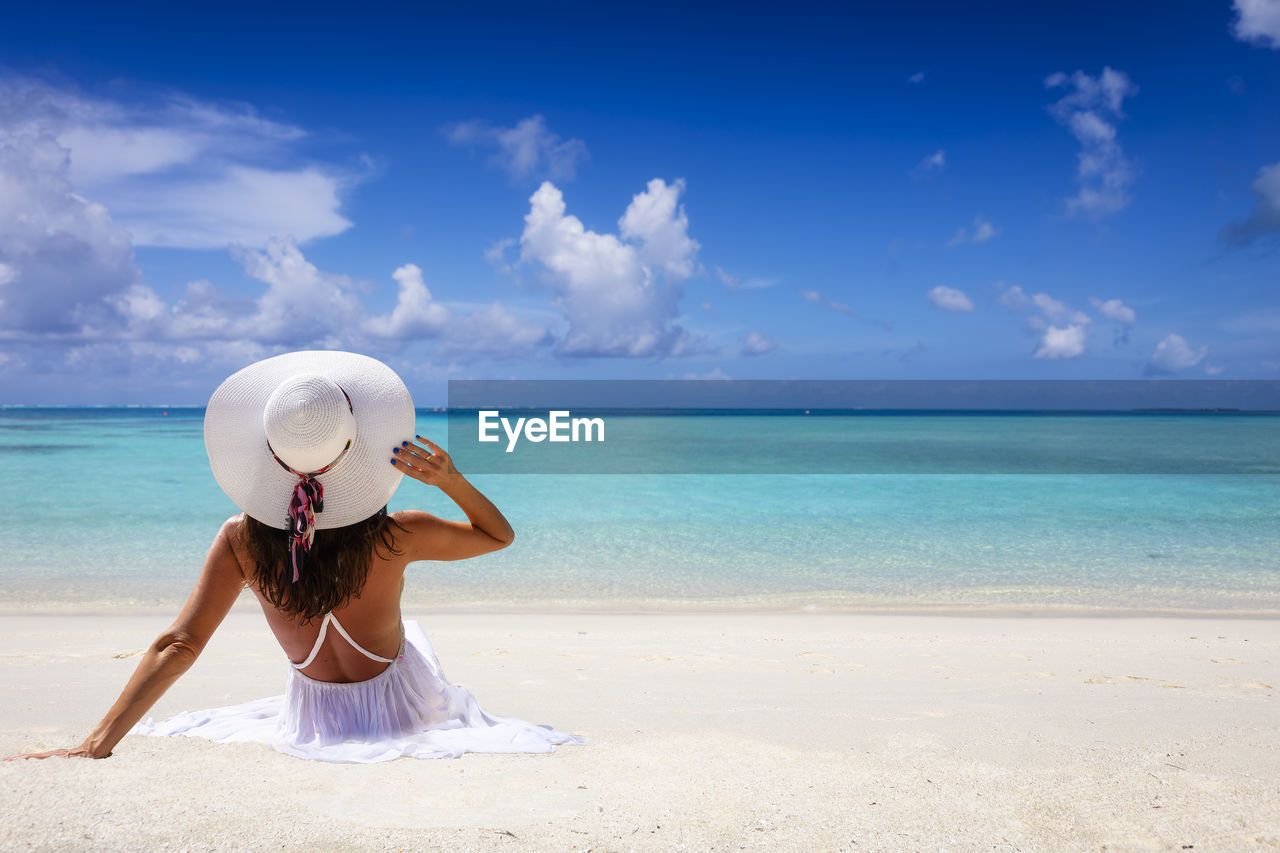 WOMAN LOOKING AT SEA SHORE