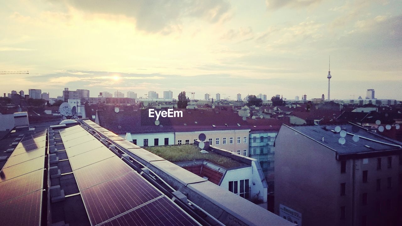 High angle view of solar panels on building roof in city