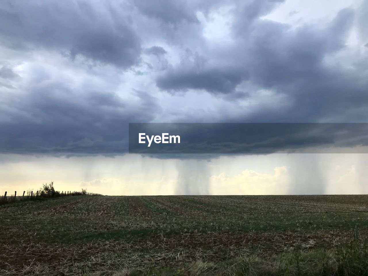 VIEW OF STORM CLOUDS OVER LAND