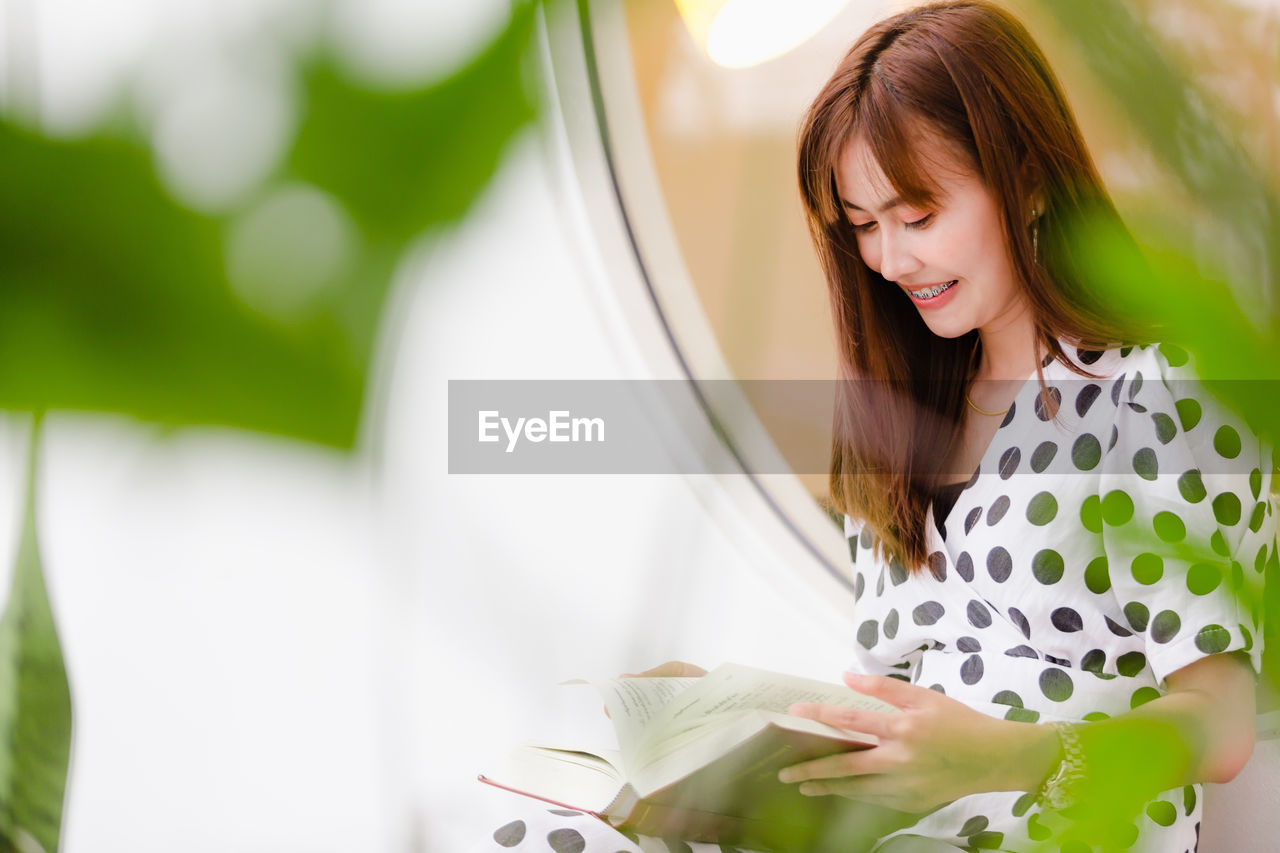 Young woman reading book