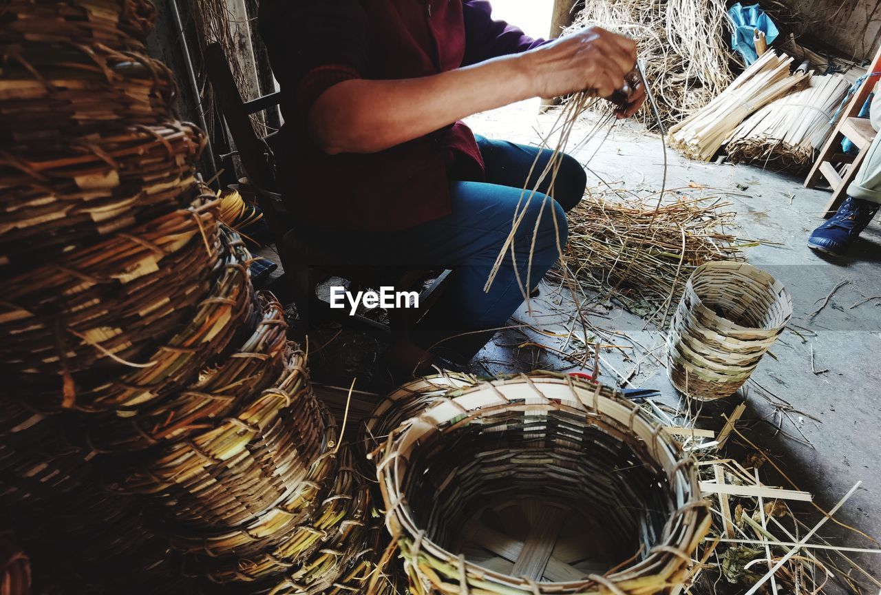 Low section of man working in basket