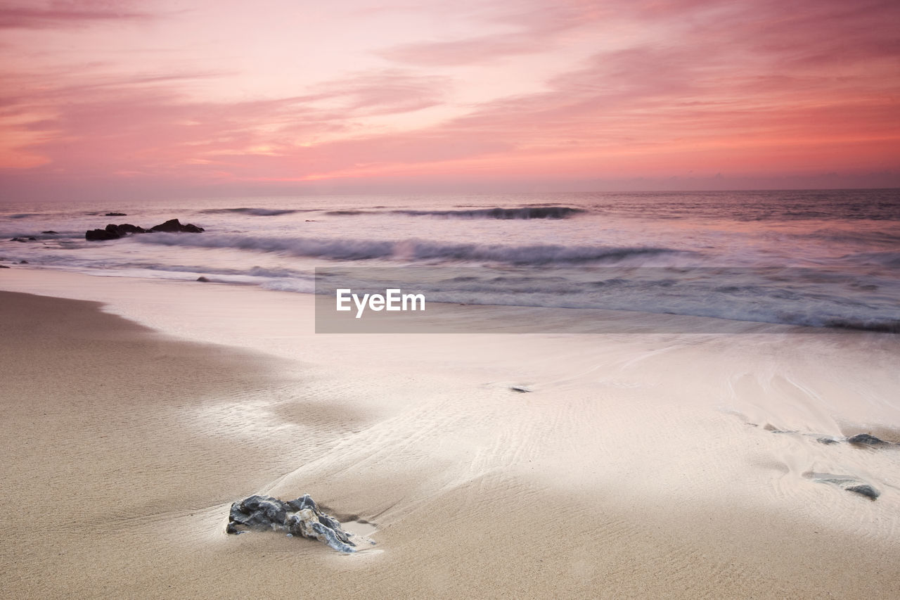 SCENIC VIEW OF BEACH DURING SUNSET