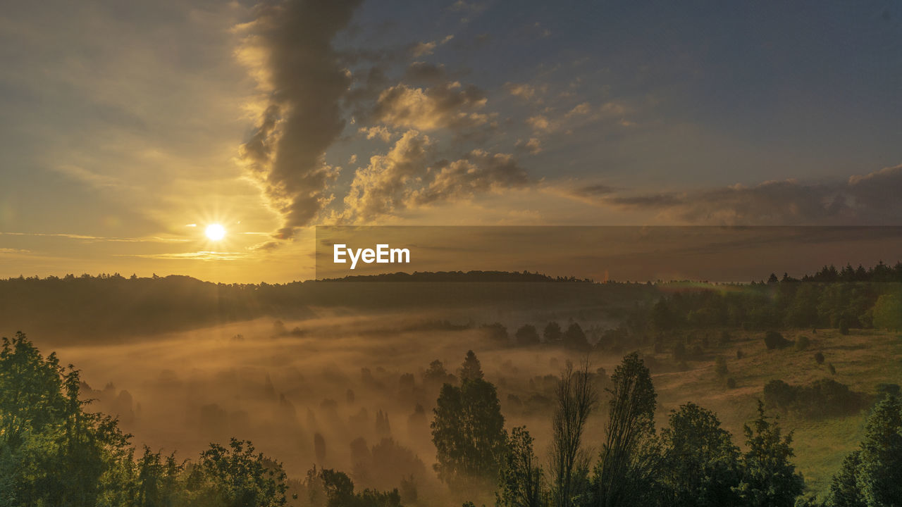 SCENIC VIEW OF LANDSCAPE AGAINST ORANGE SKY