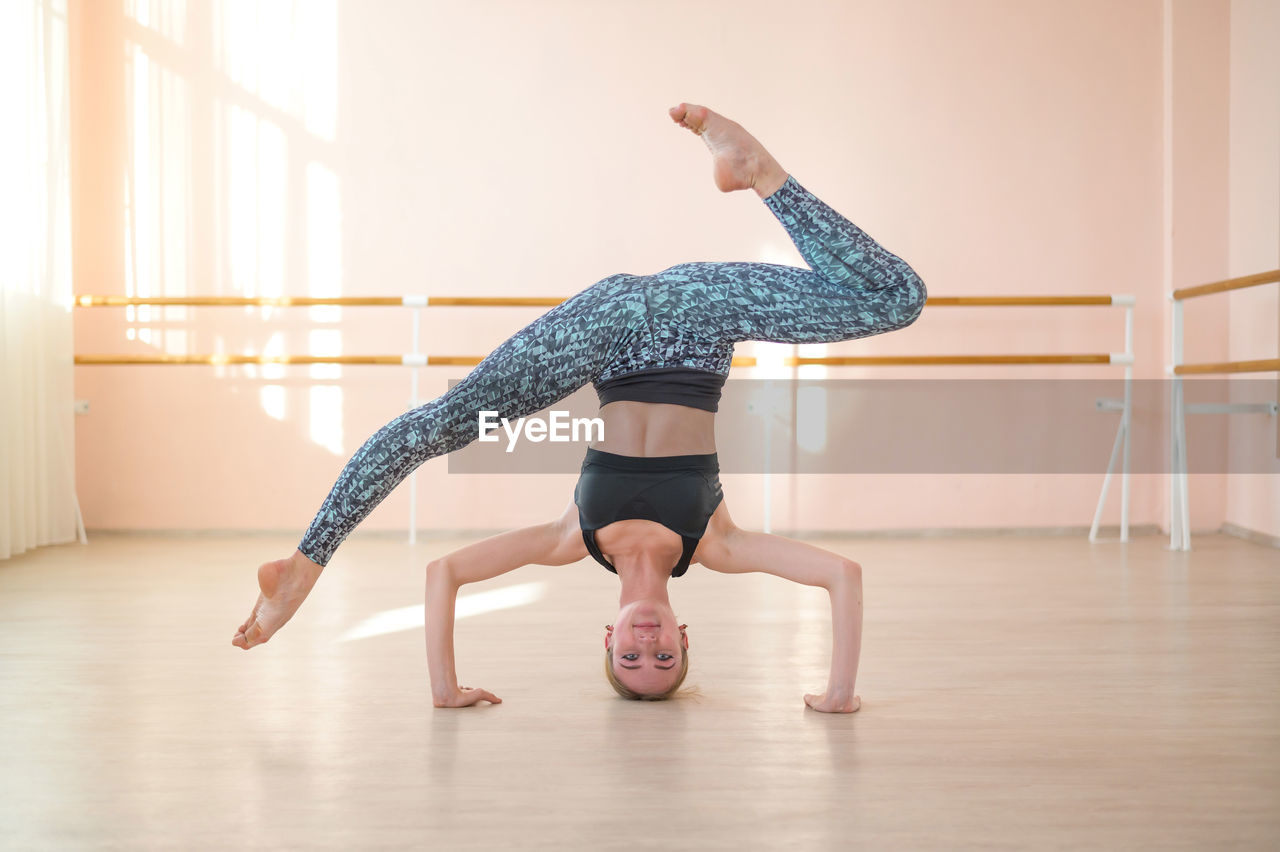 full length of woman exercising on floor