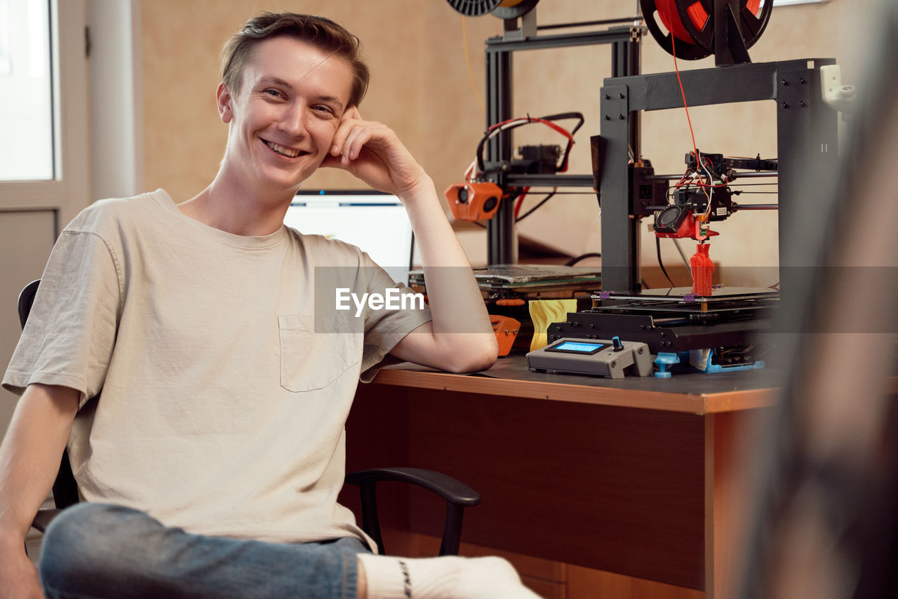 Portrait of smiling man sitting on table