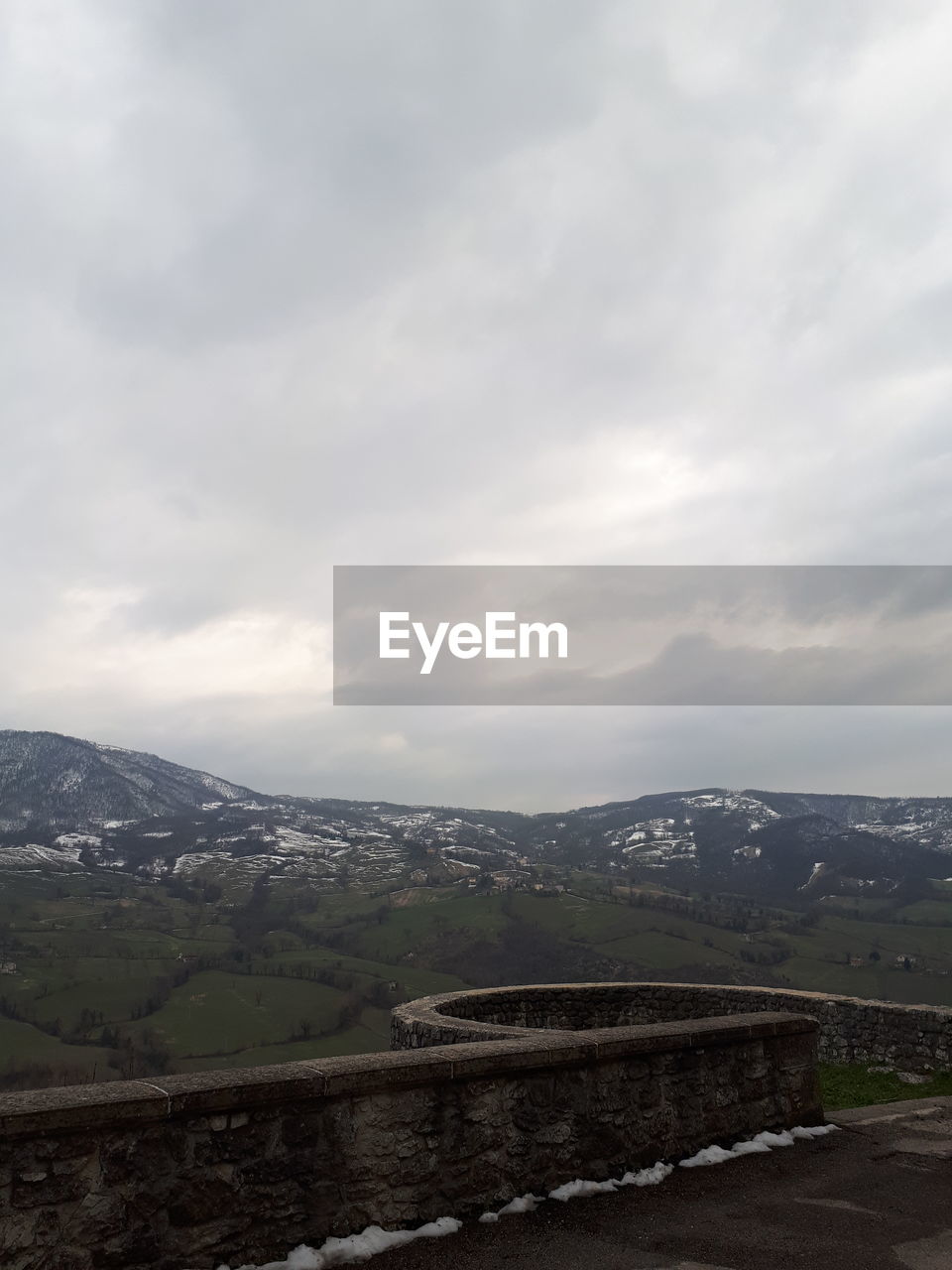 Road by mountain against sky