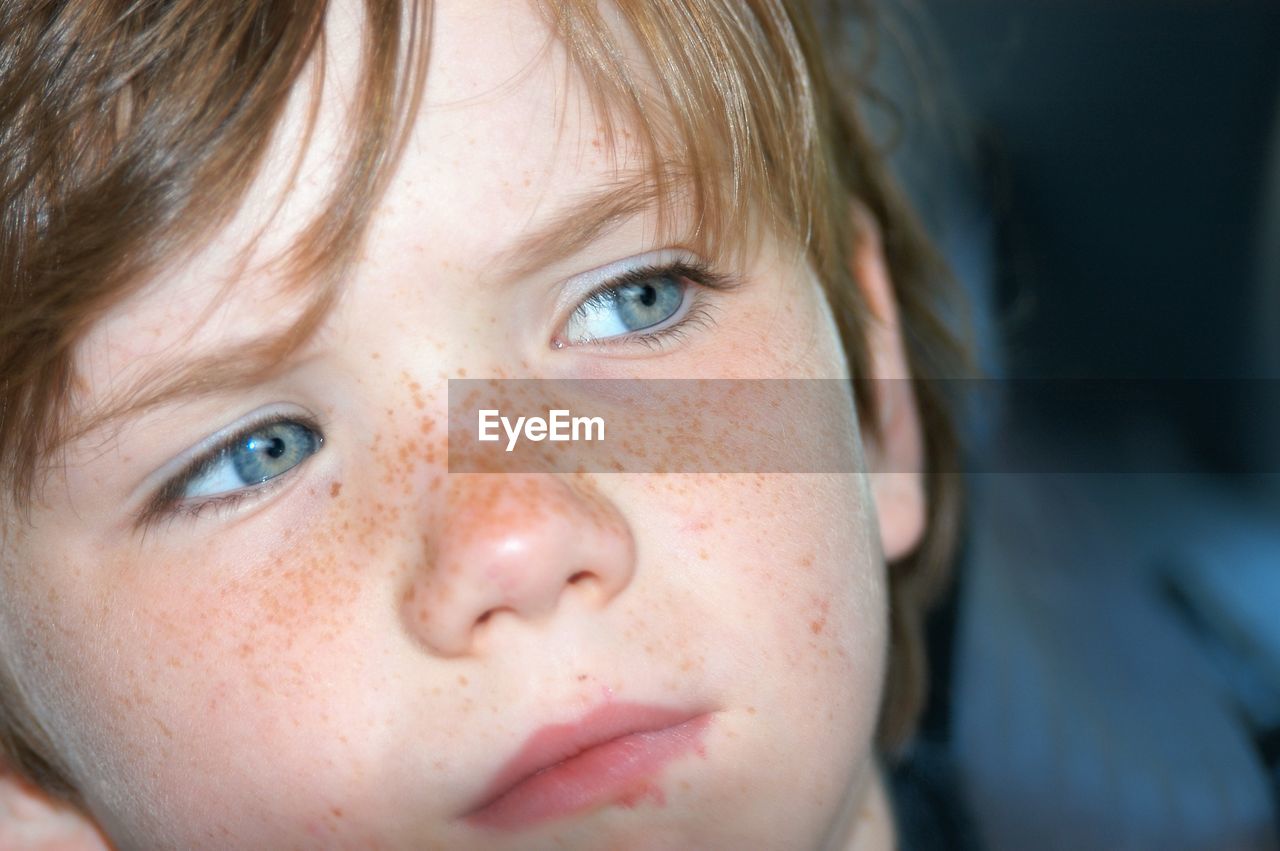 Close-up of cute boy looking away