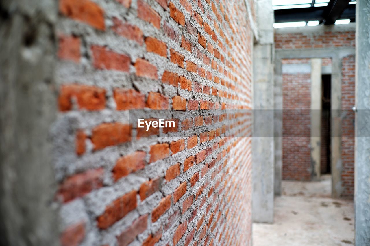 CLOSE-UP OF BRICK WALL WITH OLD BUILDING