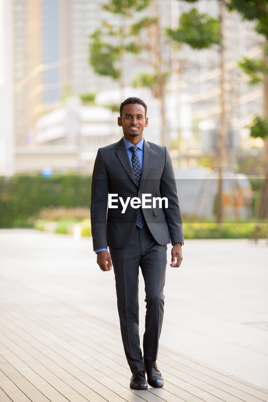 Portrait of businessman standing in city