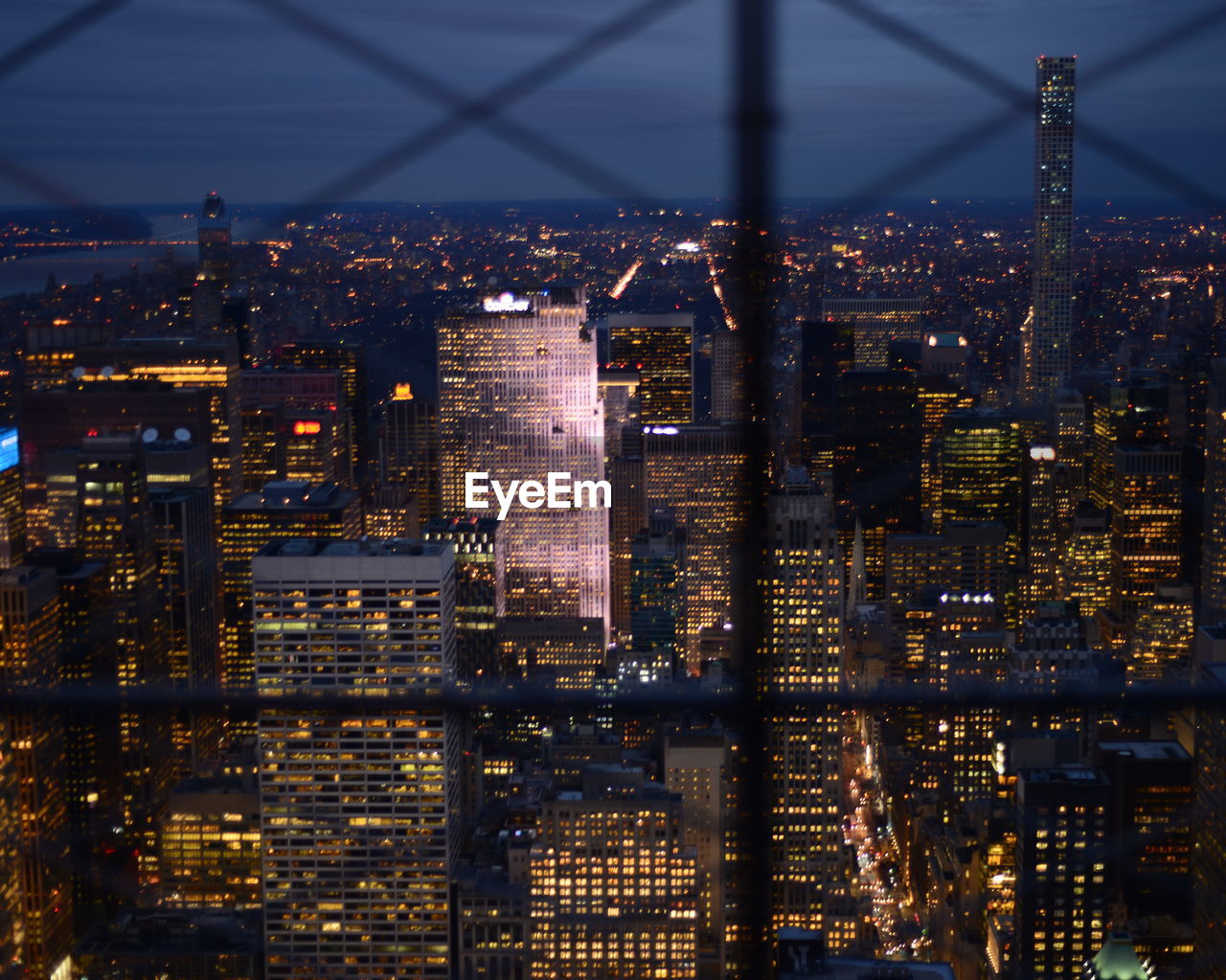 VIEW OF ILLUMINATED CITYSCAPE AT NIGHT