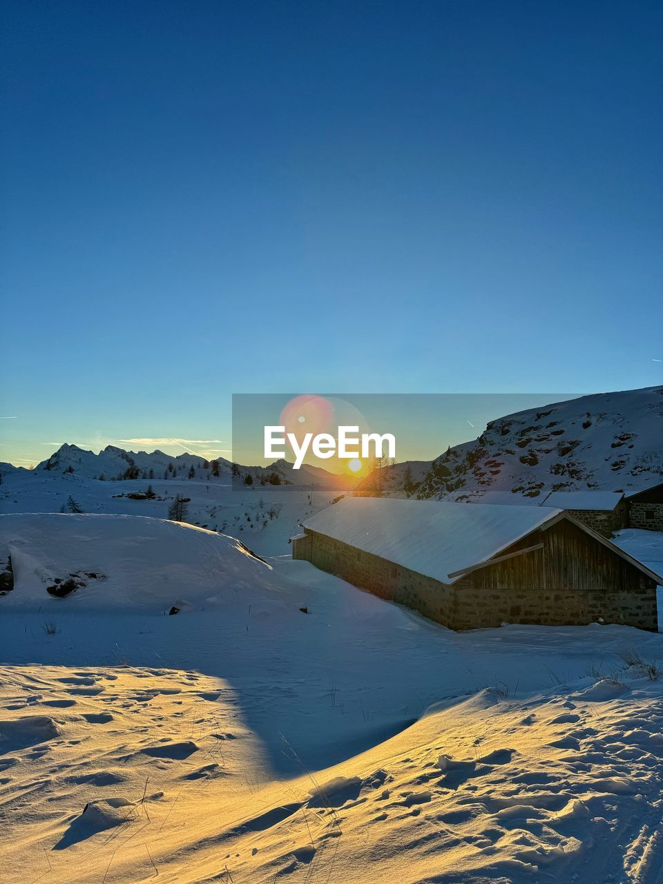 scenic view of snow covered mountain against clear blue sky
