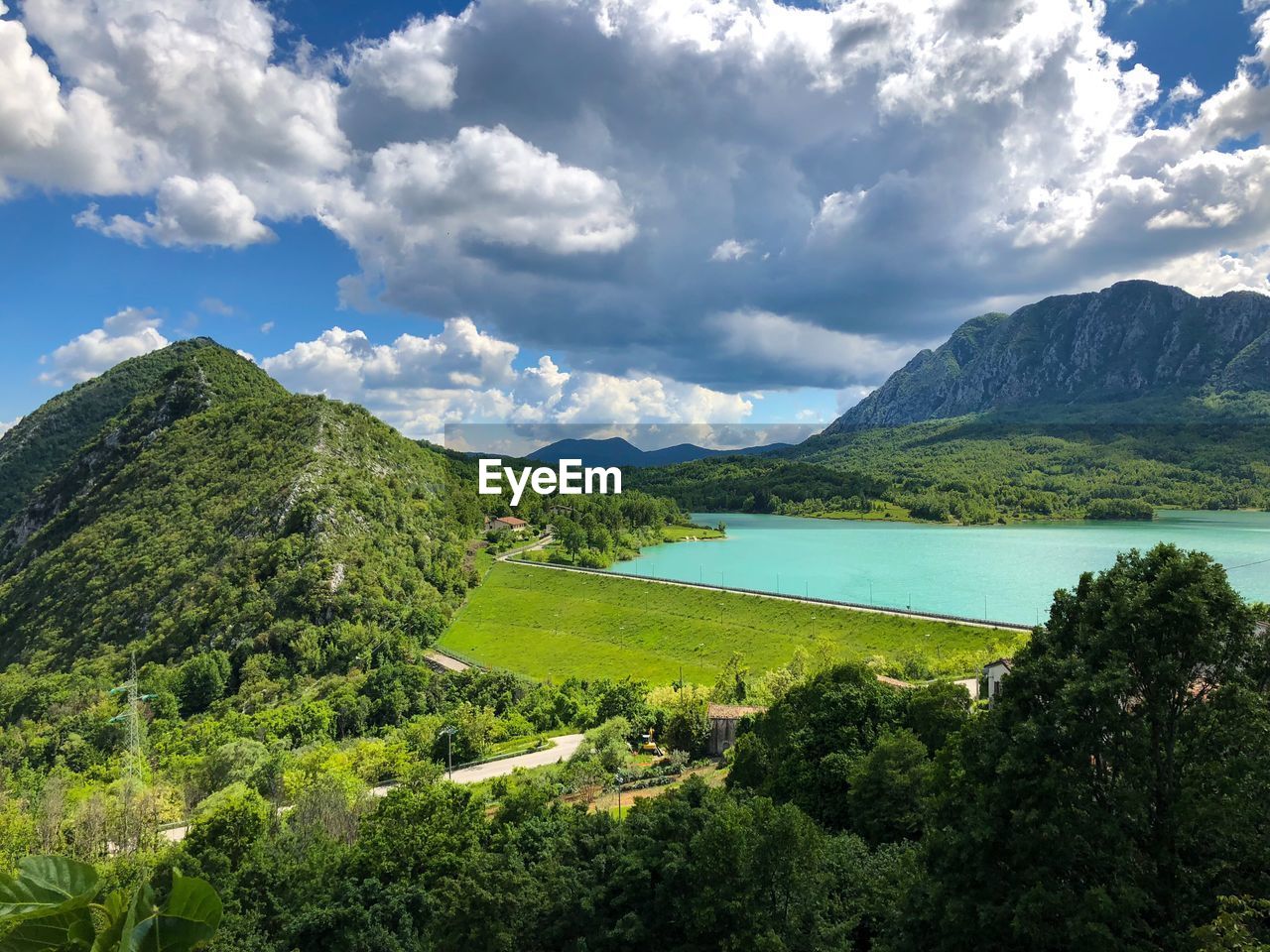 Scenic view of lake and mountains against sky