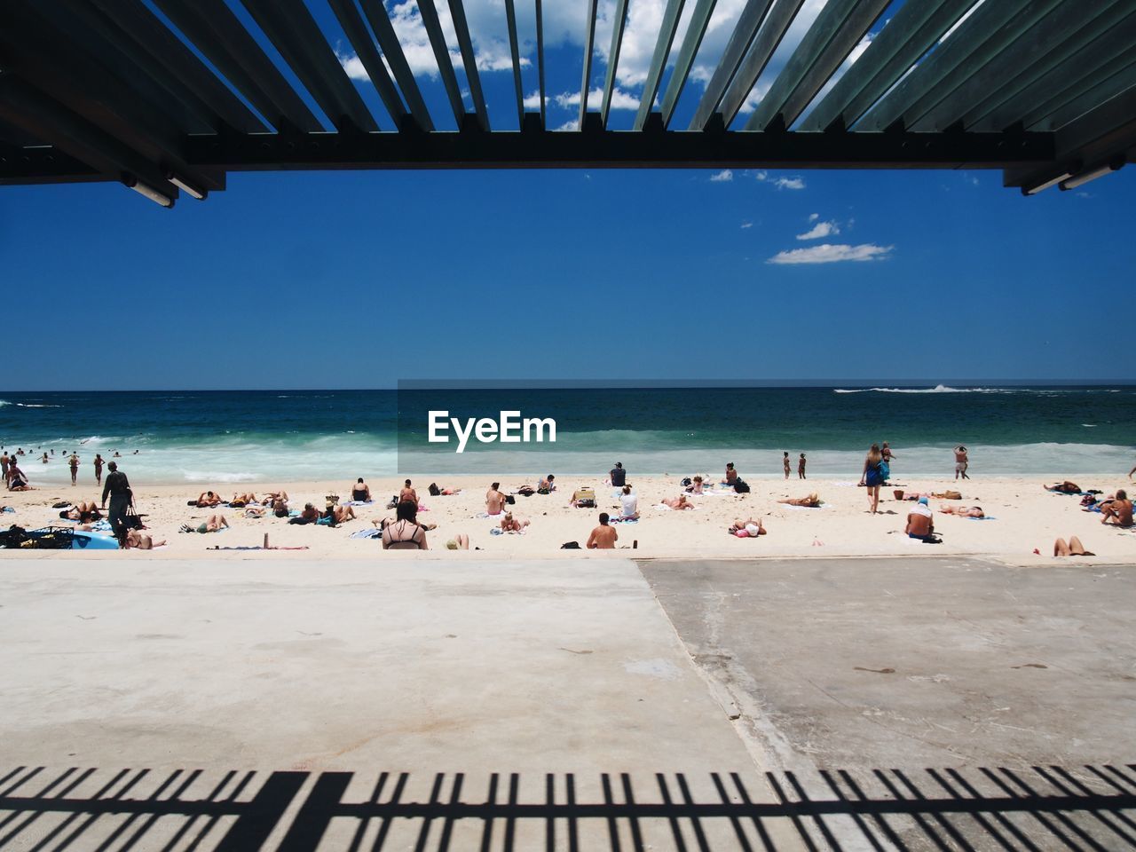 People at beach against sky during summer