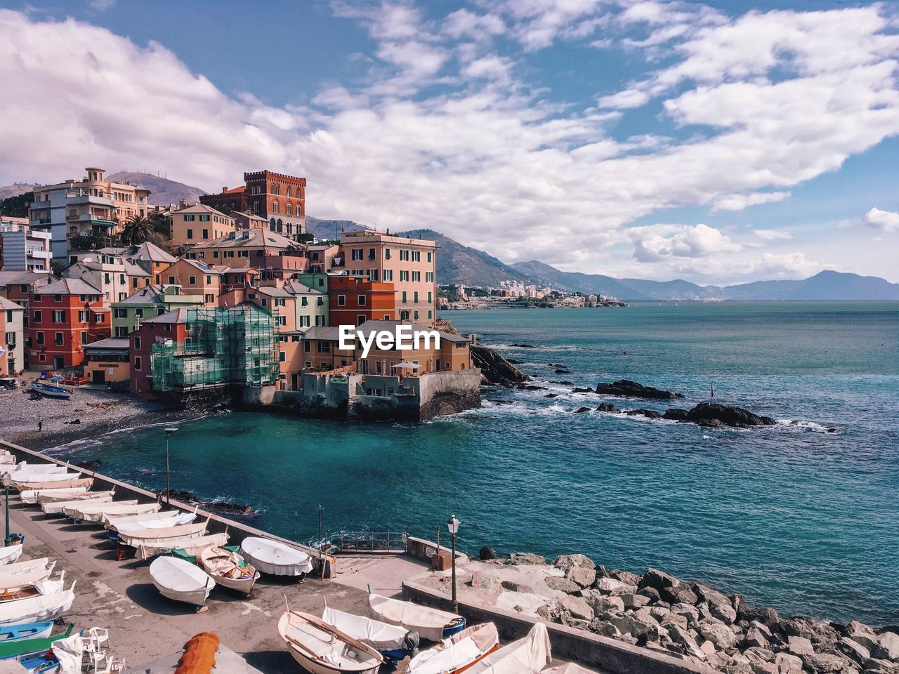 Scenic view of sea by buildings against sky