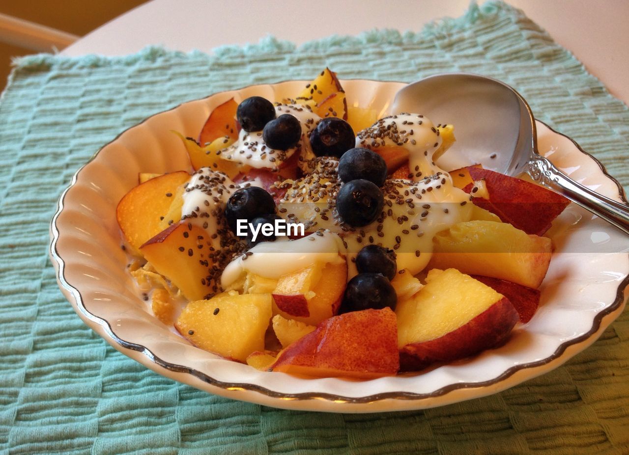 Close-up of healthy fruit breakfast served in plate on table