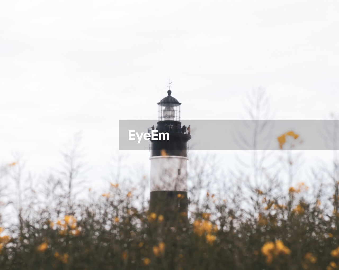 LOW ANGLE VIEW OF LIGHTHOUSE AGAINST SKY DURING WINTER