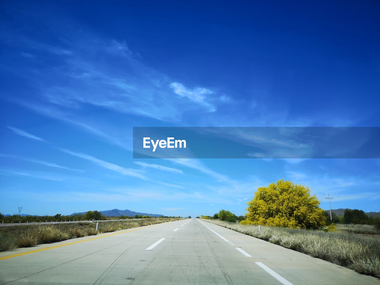 EMPTY ROAD AGAINST SKY