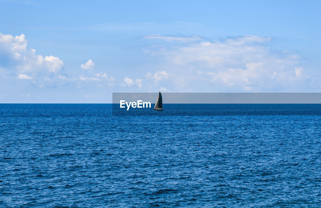 Sailboat on horizon, blue sea, summer, travel, vacation.