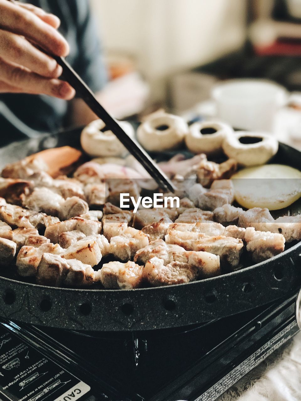 Cropped hand preparing food on stove