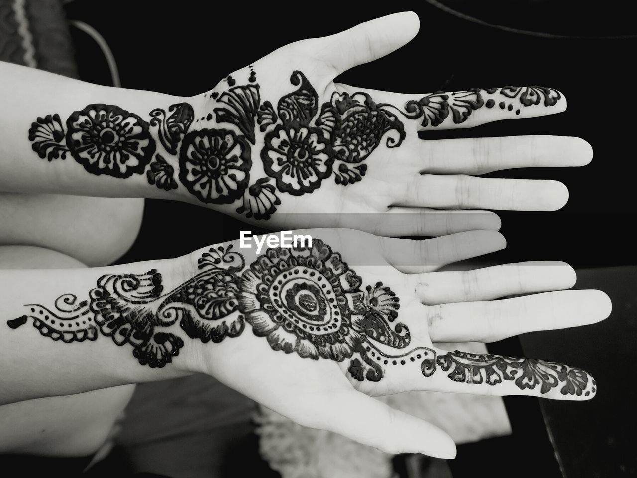 CLOSE-UP OF WOMAN HAND WITH TATTOO ON BLACK BACKGROUND