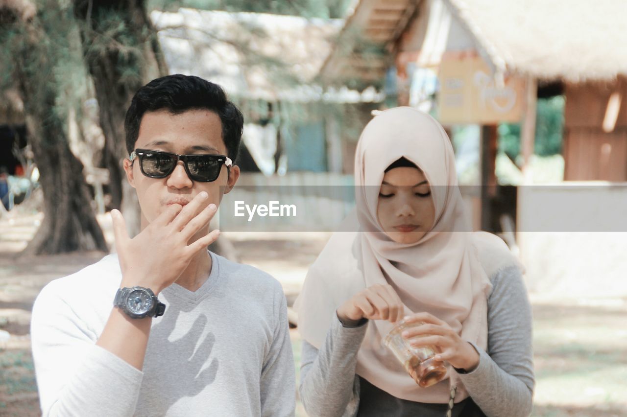 Couple having drink outdoors in sunny day