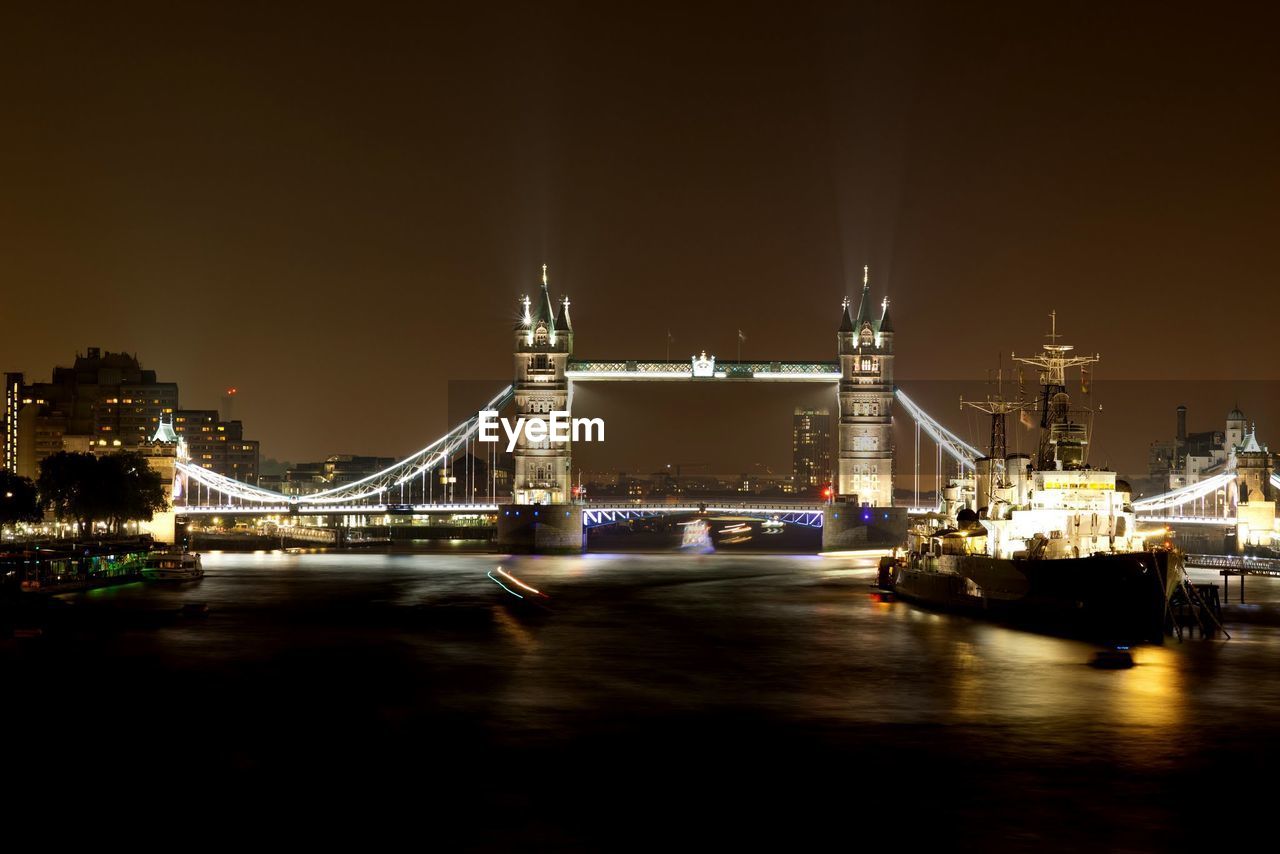 Illuminated tower bridge on thames river at night