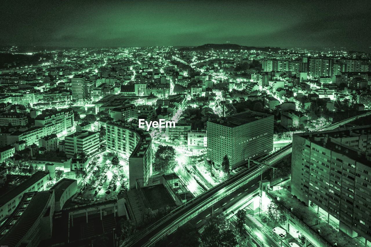 High angle view of illuminated cityscape against sky at night