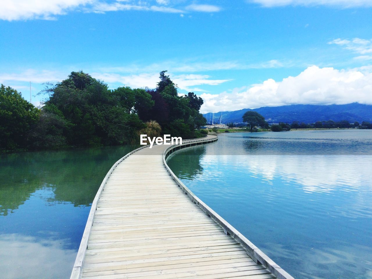 PIER OVER LAKE AGAINST SKY