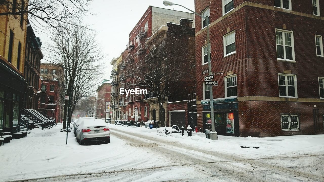 VIEW OF CITY STREET WITH SNOW