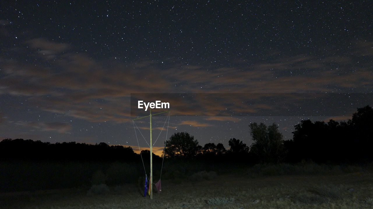 Scenic view of field against sky at night