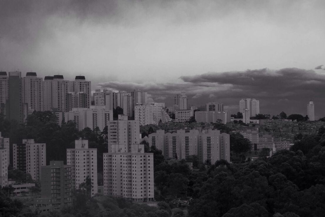 VIEW OF CITYSCAPE AGAINST CLOUDY SKY