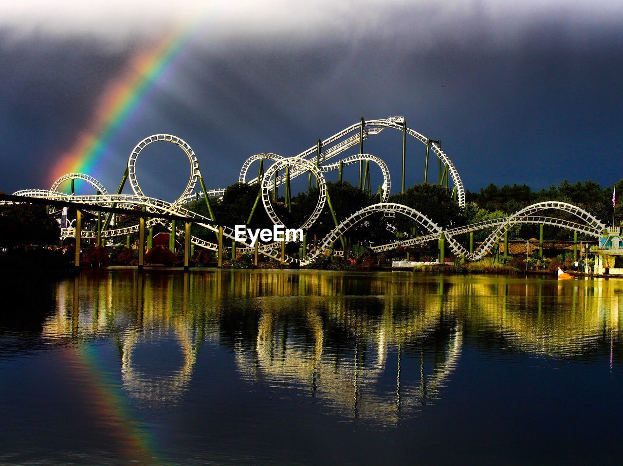 Scenic view of rainbow over river against sky