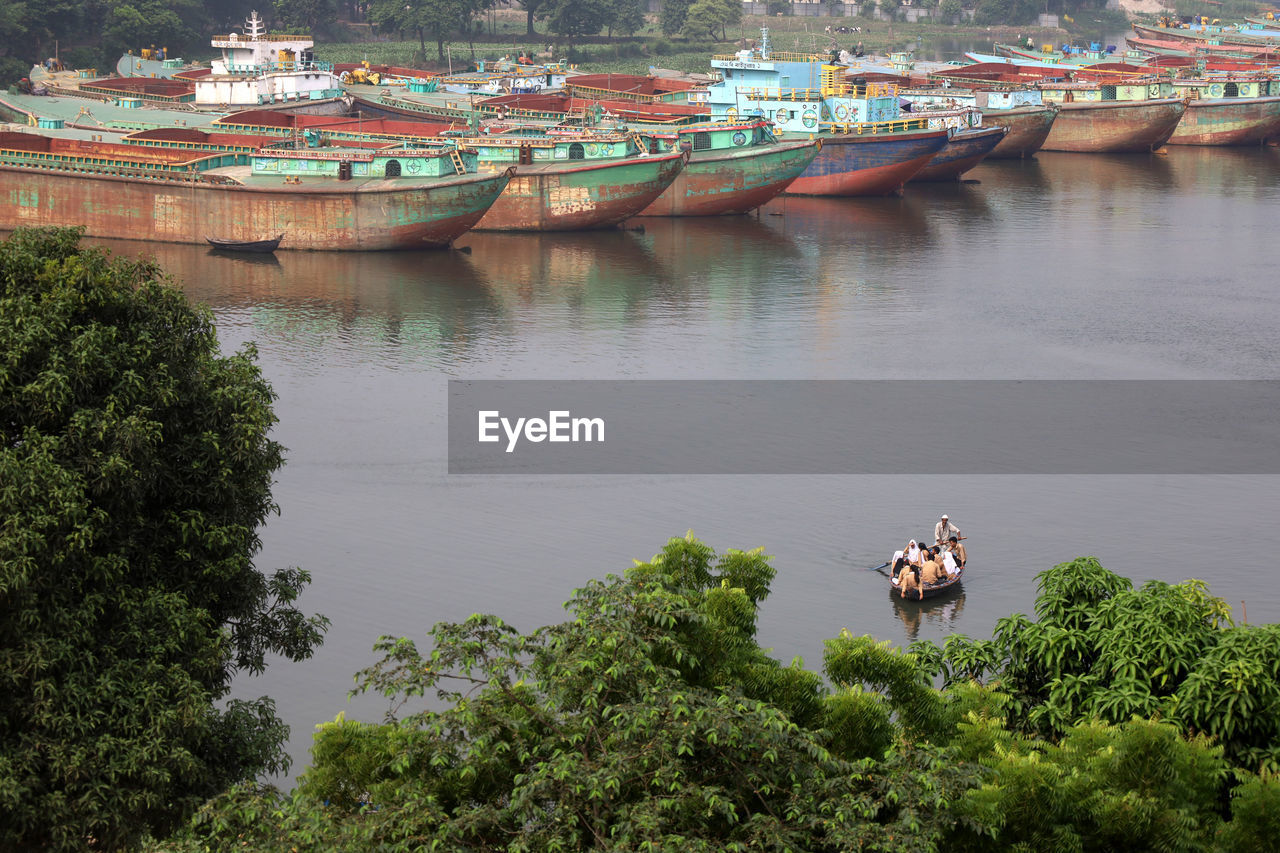 water, river, nautical vessel, transportation, plant, tree, architecture, nature, mode of transportation, ship, boat, high angle view, built structure, day, outdoors, travel, waterway, building exterior, vehicle, travel destinations, watercraft, no people, city, reflection, building