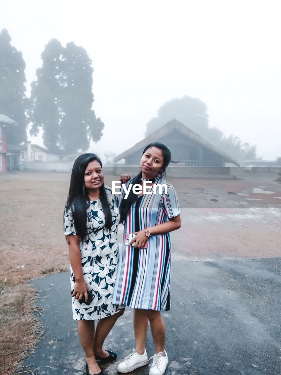 HAPPY FRIENDS STANDING ON MOUNTAIN