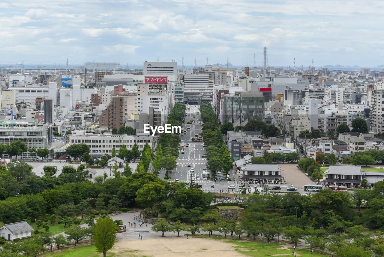 High angle view of buildings and trees against sky