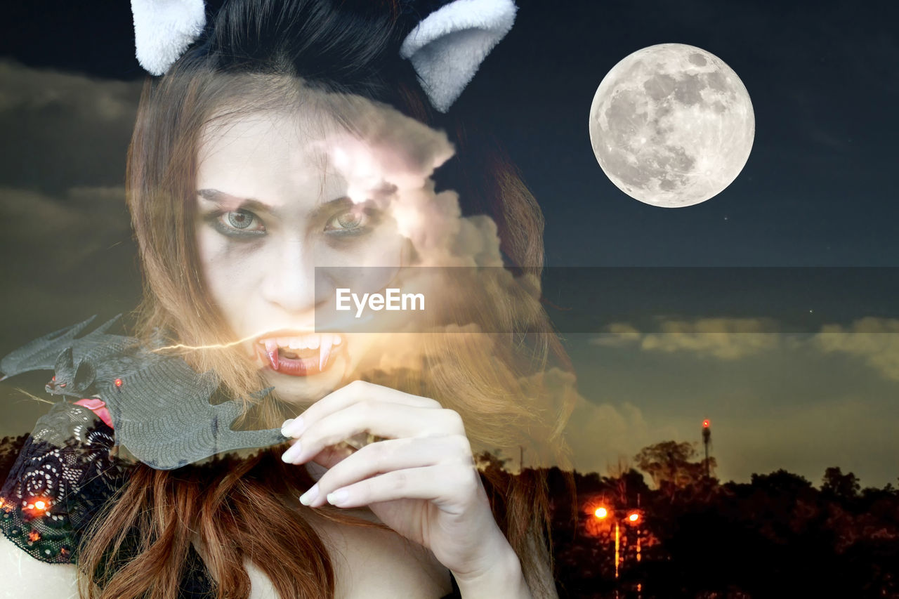 Digital composite of evil woman against full moon in sky at night