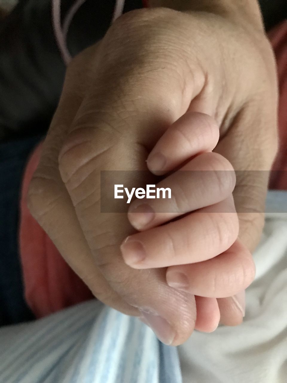 CLOSE-UP OF BABY HAND WITH TATTOO