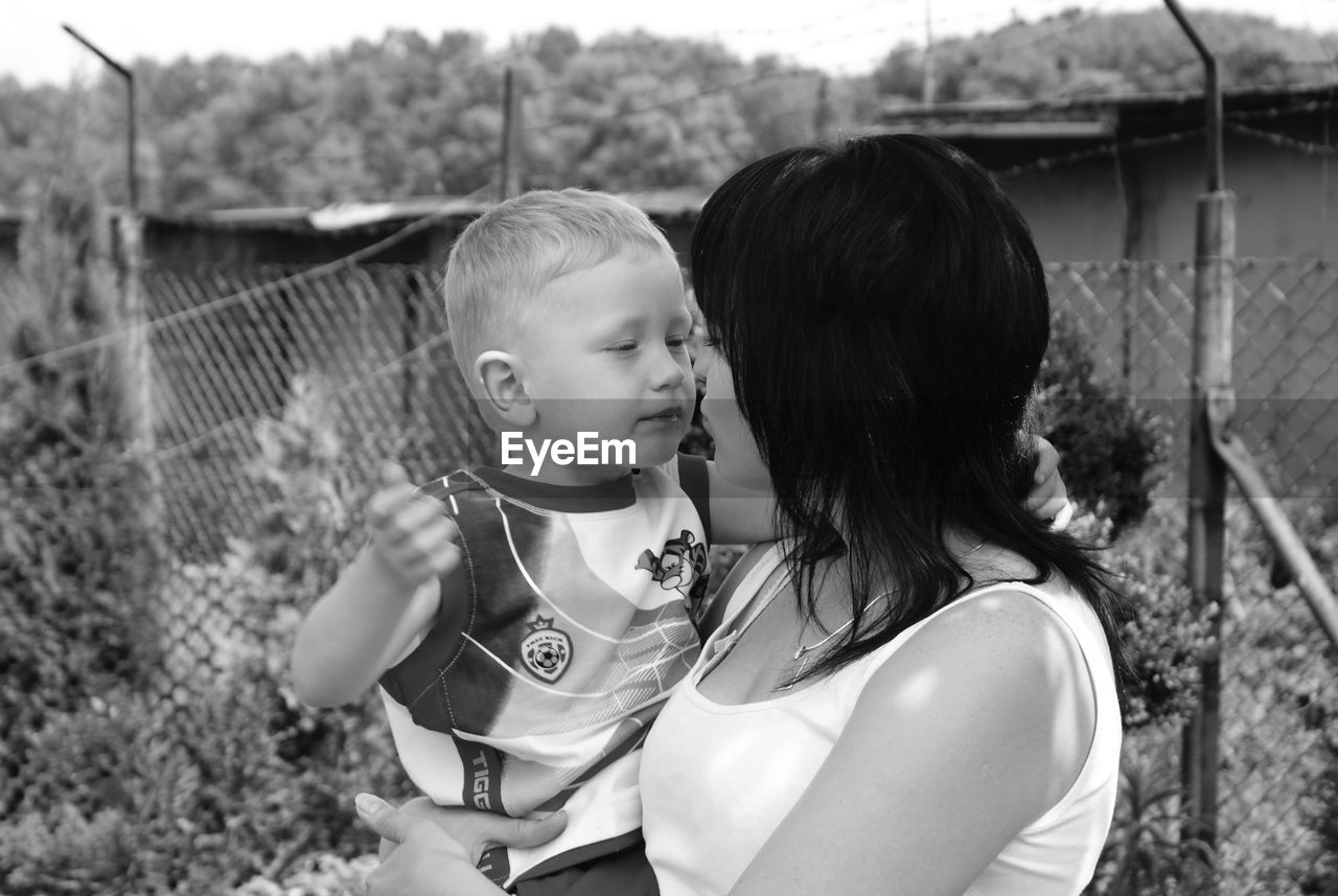 Mother holding child outdoors