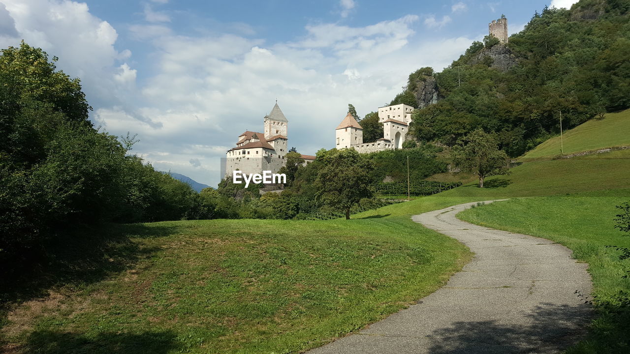 PANORAMIC VIEW OF BUILDINGS AND TREES AGAINST SKY