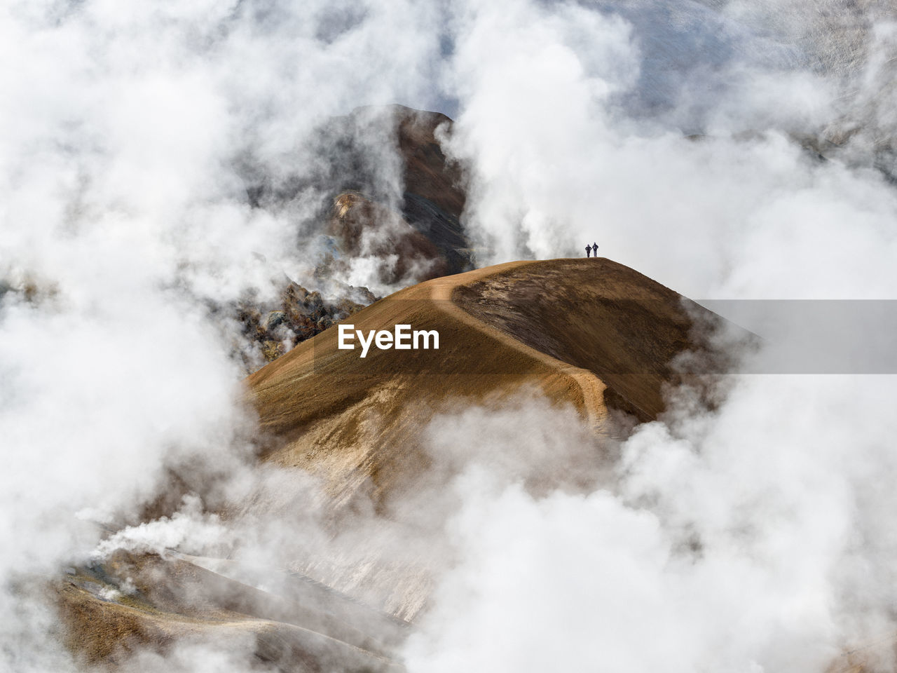 Travelers walking along mountain ridge