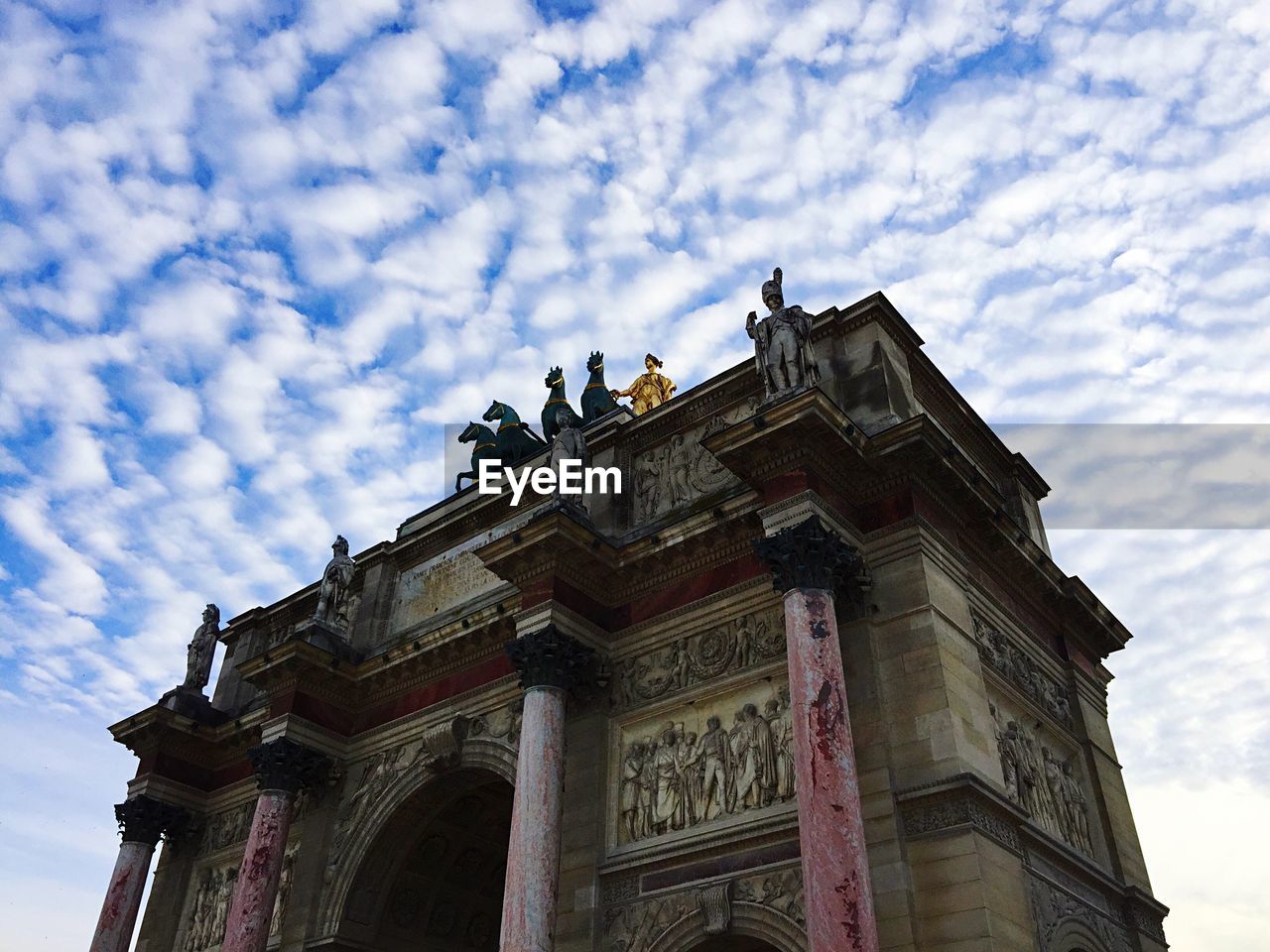 LOW ANGLE VIEW OF HISTORICAL BUILDING AGAINST CLOUDY SKY