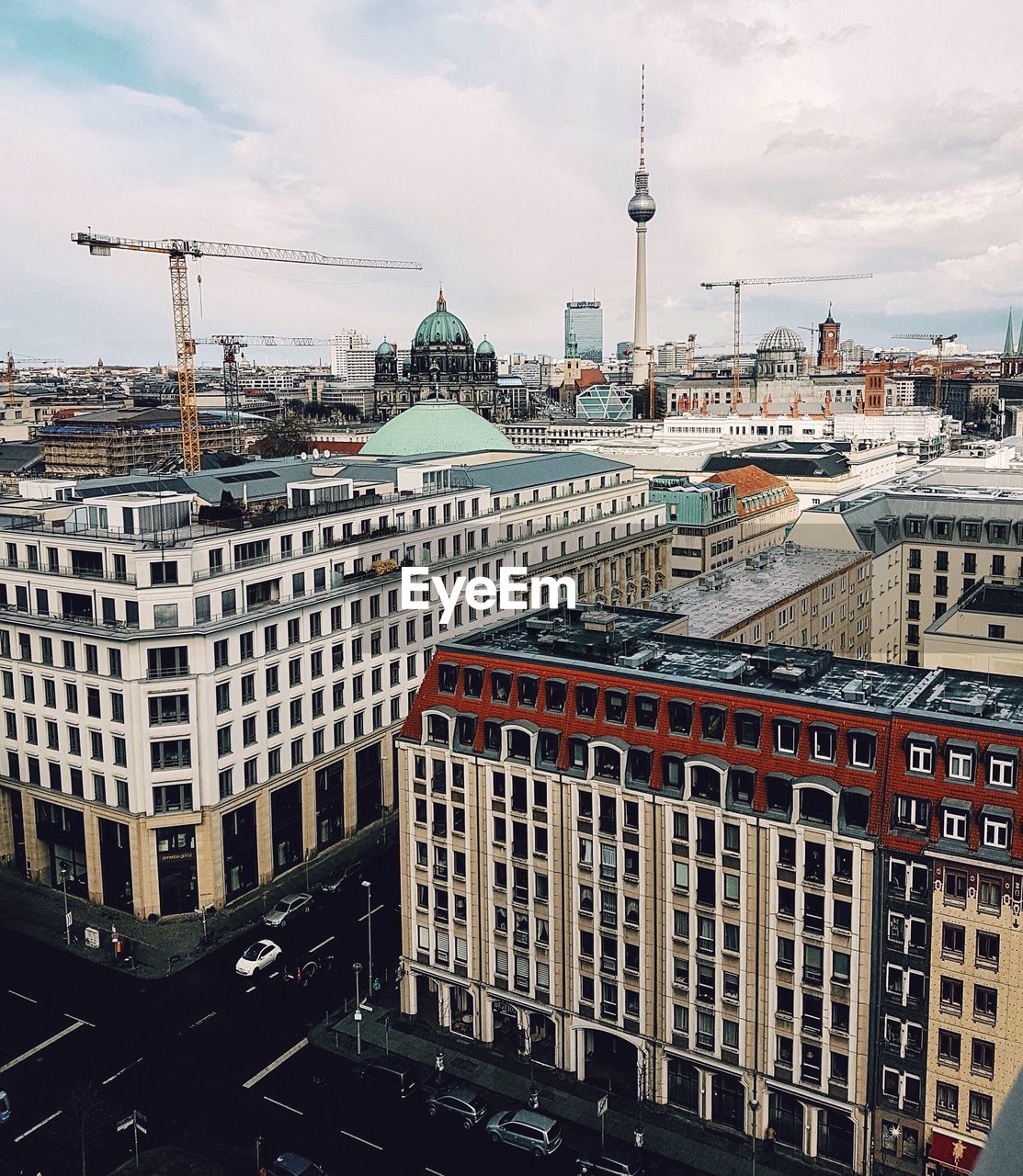 Fernsehturm amidst cityscape against sky