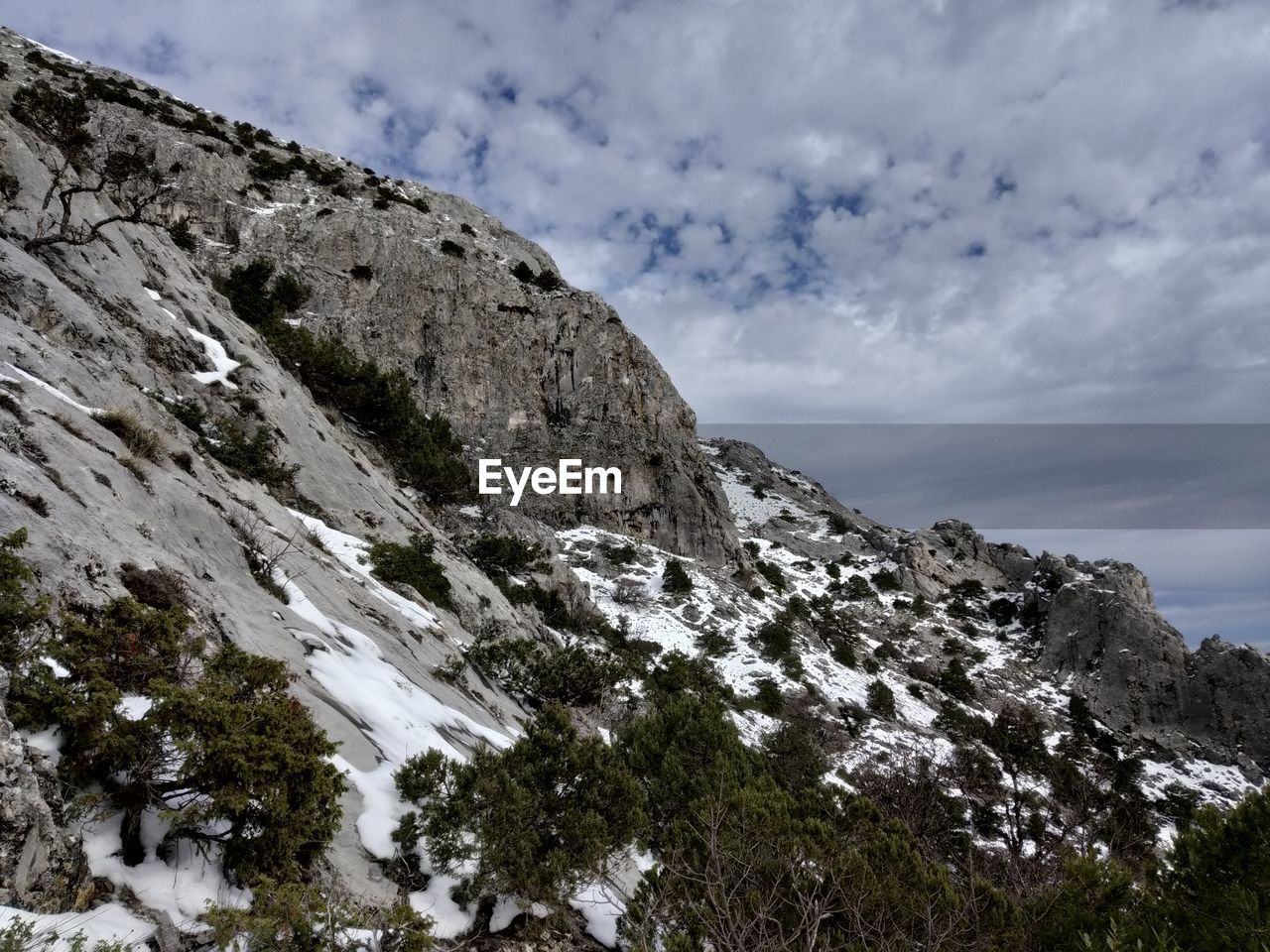 Low angle view of snowcapped mountains against sky