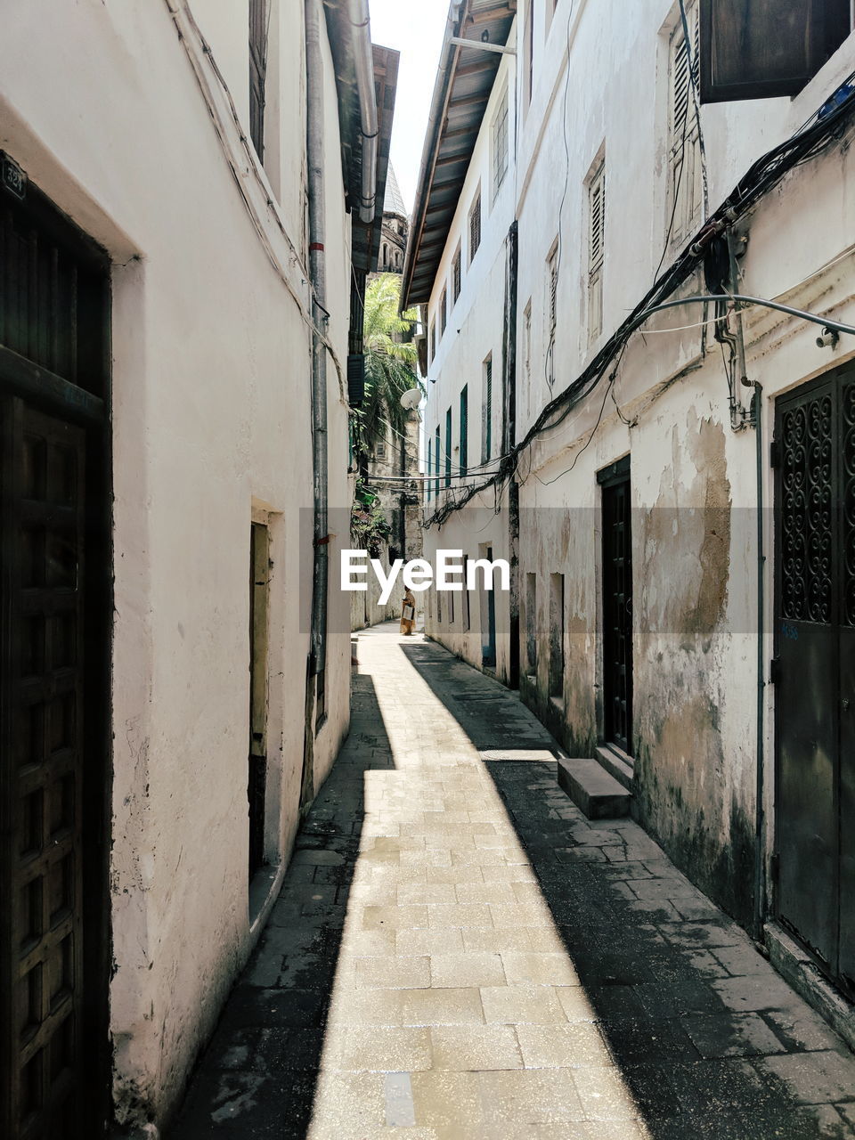 Narrow alley amidst buildings in old city