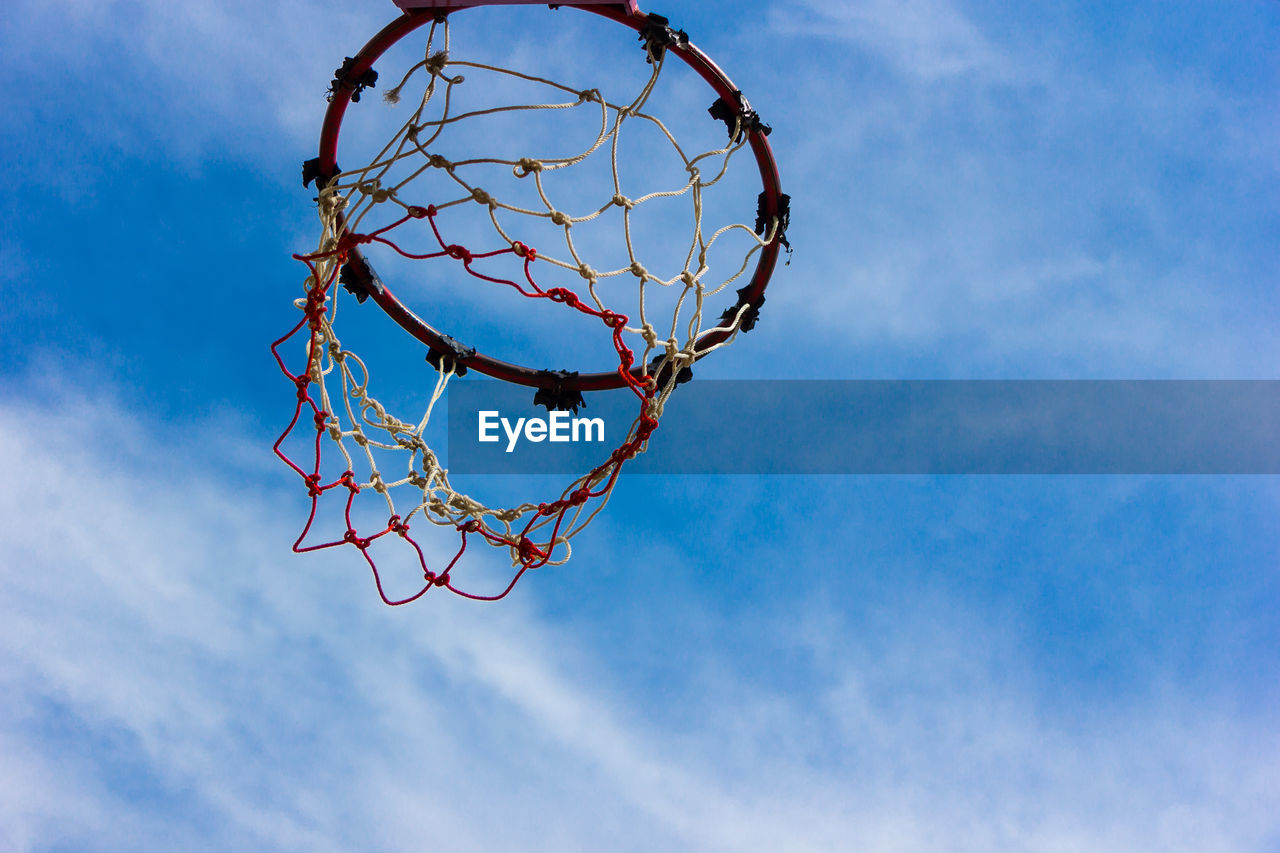 DIRECTLY BELOW SHOT OF BASKETBALL HOOP AGAINST SKY