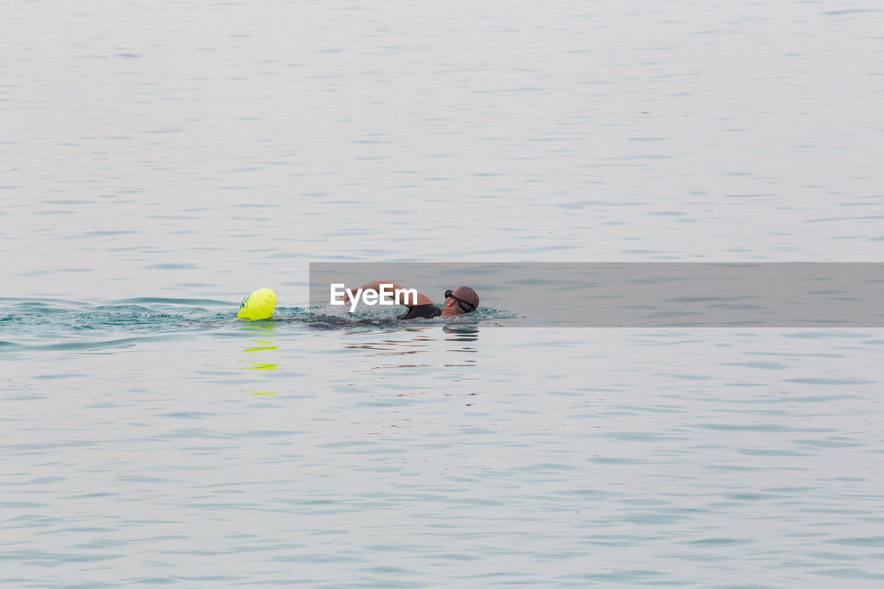 Portrait of men swimming in sea