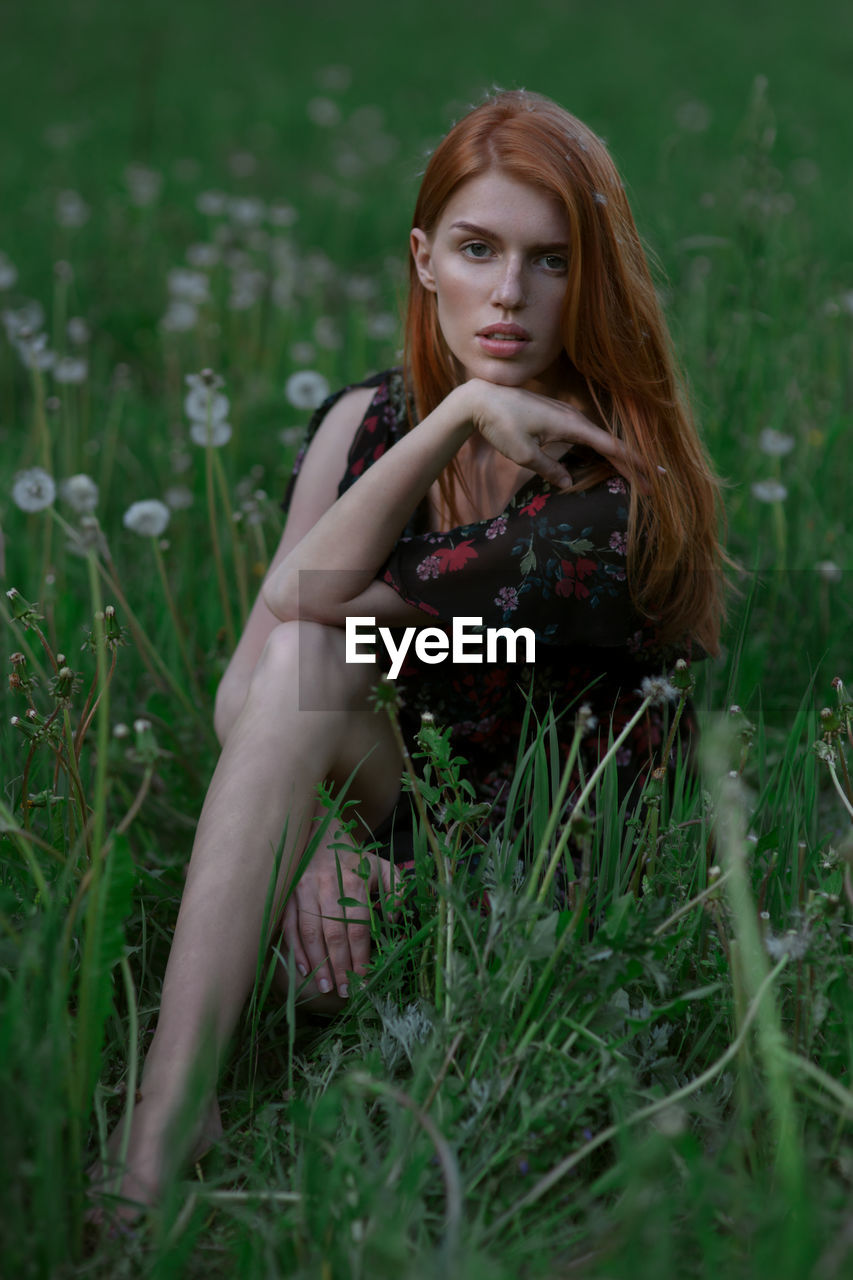 PORTRAIT OF YOUNG WOMAN IN GRASS