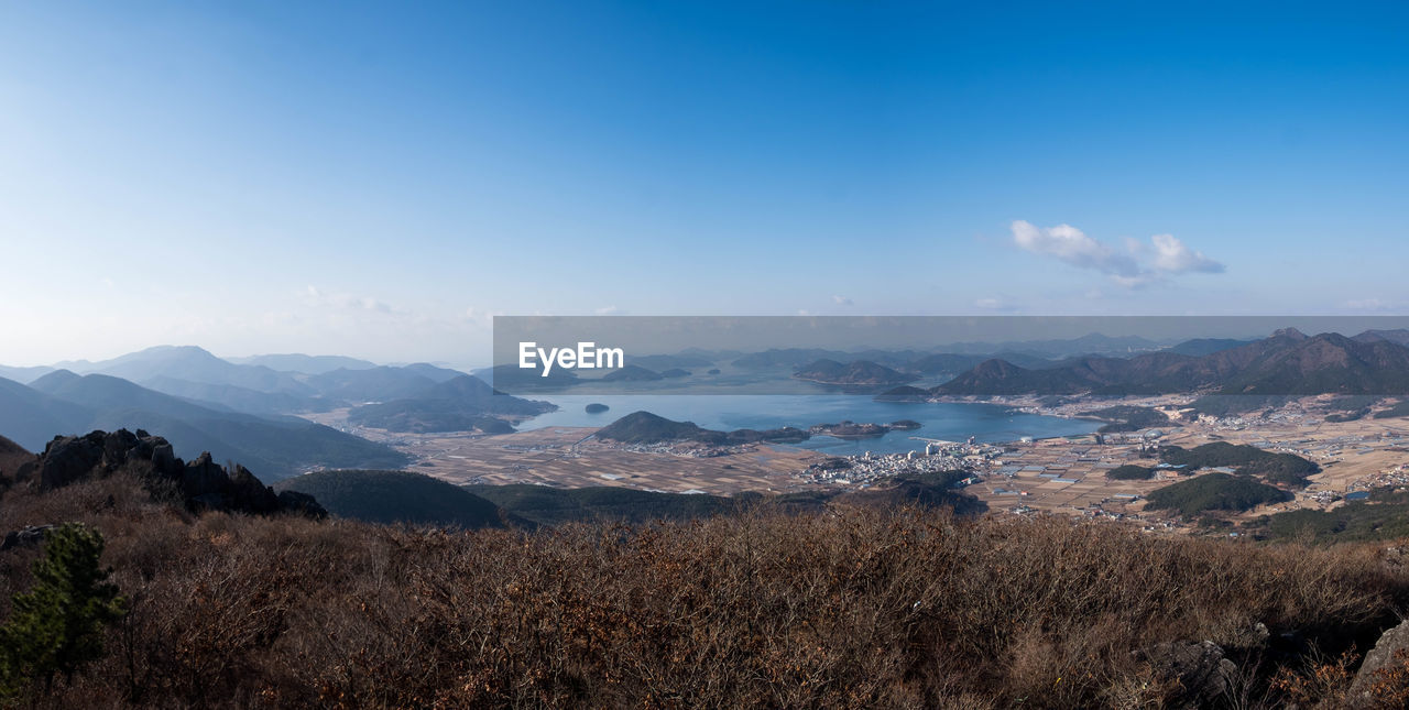Scenic view of mountains against blue sky