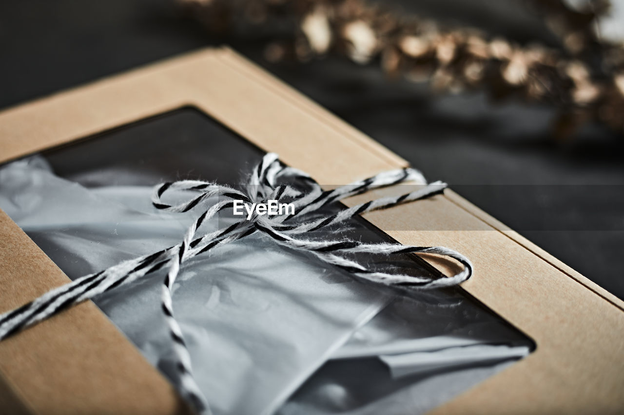 box, gift, close-up, paper, celebration, no people, selective focus, brown, indoors, wedding favors, still life, ribbon